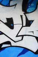 Background image of a concrete wall with a piece of abstract graffiti pattern. Street art, vandalism and youth hobbies photo