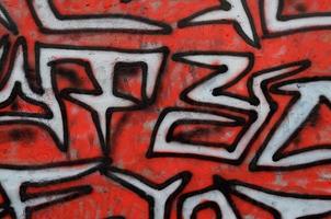 Background image of a concrete wall with a piece of abstract graffiti pattern. Street art, vandalism and youth hobbies photo