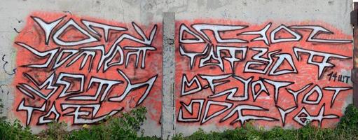 Background image of a concrete wall with a piece of abstract graffiti pattern. Street art, vandalism and youth hobbies photo