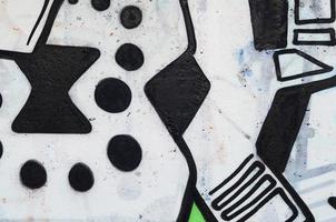 Background image of a concrete wall with a piece of abstract graffiti pattern. Street art, vandalism and youth hobbies photo