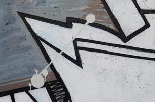 Background image of a concrete wall with a piece of abstract graffiti pattern. Street art, vandalism and youth hobbies photo