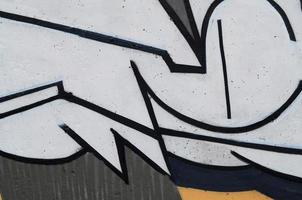 Background image of a concrete wall with a piece of abstract graffiti pattern. Street art, vandalism and youth hobbies photo