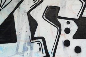 Background image of a concrete wall with a piece of abstract graffiti pattern. Street art, vandalism and youth hobbies photo