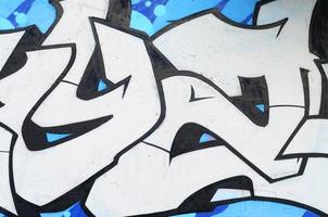 Background image of a concrete wall with a piece of abstract graffiti pattern. Street art, vandalism and youth hobbies photo