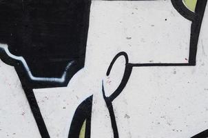 Background image of a concrete wall with a piece of abstract graffiti pattern. Street art, vandalism and youth hobbies photo