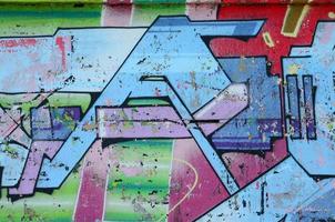 Fragment of graffiti drawings. The old wall decorated with paint stains in the style of street art culture. Colored background texture in cold tones photo