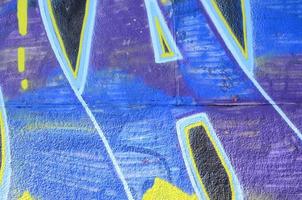 Fragment of graffiti drawings. The old wall decorated with paint stains in the style of street art culture. Colored background texture in cold tones photo