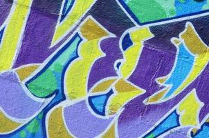 Fragment of graffiti drawings. The old wall decorated with paint stains in the style of street art culture. Colored background texture in cold tones photo