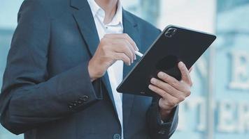 Businessman using tablet analyzing sales data and economic growth graph chart. Business strategy. Abstract icon. Digital marketing. video