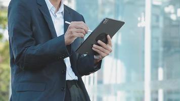 Businessman using tablet analyzing sales data and economic growth graph chart. Business strategy. Abstract icon. Digital marketing. video