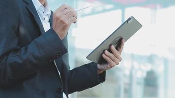 Businessman using tablet analyzing sales data and economic growth graph chart. Business strategy. Abstract icon. Digital marketing. video
