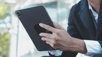 Businessman using tablet analyzing sales data and economic growth graph chart. Business strategy. Abstract icon. Digital marketing. video