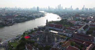 une vue aérienne de la pagode se dresse bien en vue au temple wat arun avec la rivière chao phraya, l'attraction touristique la plus célèbre de bangkok, thaïlande video