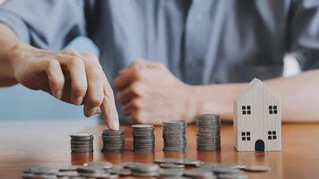 businessman holding coins putting in glass with using calculator to calculate concept saving money for finance accounting, Business, finance, investment, Financial planning. video