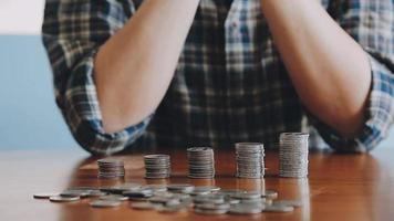 businessman holding coins putting in glass with using calculator to calculate concept saving money for finance accounting, Business, finance, investment, Financial planning. video