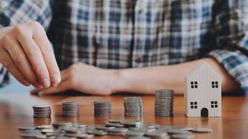 businessman holding coins putting in glass with using calculator to calculate concept saving money for finance accounting, Business, finance, investment, Financial planning. video