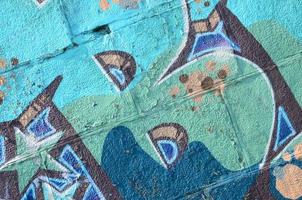Fragment of graffiti drawings. The old wall decorated with paint stains in the style of street art culture. Colored background texture in cold tones photo