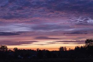 Image of a colorful and high-contrast sunrise with bright cloud formations taken in Germany photo