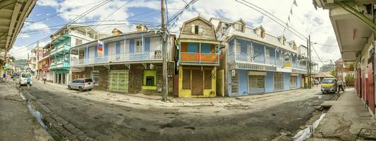 Panoramic picture of a typical street of houses on the carrebbian island of Dominica during daytime photo