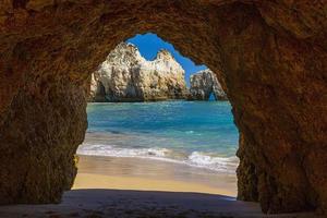 Natural caves in the impressive cliffs of Algarve coast in Portugal in summer photo