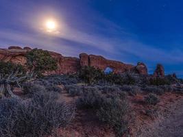 Panoramic picture of impressive sandstone formations in Arches National Park at night in winter photo