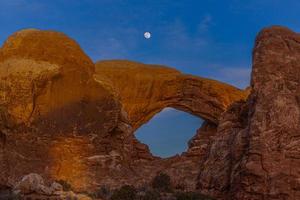 imagen panorámica de impresionantes formaciones de arenisca en el parque nacional arches por la noche en invierno foto