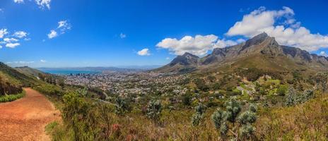 Panoramic view of Cape Town and Table Mountain and Signal Hilltaken from Lions Head during the day under blue sky with some white clouds photo