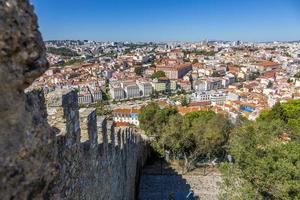 View from Castelo de Sao Jorge over Lisbon with stone wall in summer photo