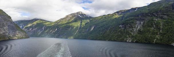 Impression from cruise ship on the way through Geiranger fjord in Norway at sunrise in summer photo