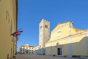 Panorama over the central square of Motovun with St. Stephen's church and city gate during the day photo