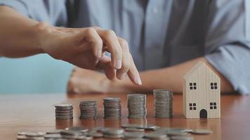 businessman holding coins putting in glass with using calculator to calculate concept saving money for finance accounting, Business, finance, investment, Financial planning. video