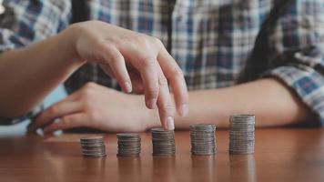 businessman holding coins putting in glass with using calculator to calculate concept saving money for finance accounting, Business, finance, investment, Financial planning. video