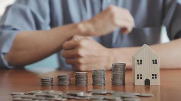 businessman holding coins putting in glass with using calculator to calculate concept saving money for finance accounting, Business, finance, investment, Financial planning. video