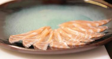 Chef Carefully Lying The Thinly Sliced Salmon Sashimi On A Plate.  -close up shot video