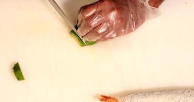 vista superior das mãos cortando abacate fresco para rolo de sushi - câmera lenta video