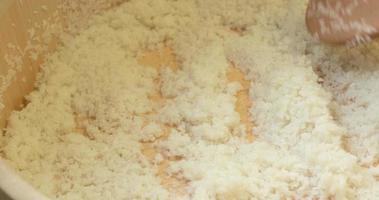 Chef Spreading White Rice Into A Wooden Basin For Sushi Dish. Making Sushi Rice. - high angle shot video