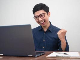 Positive man show fist up feels happy about success his working photo