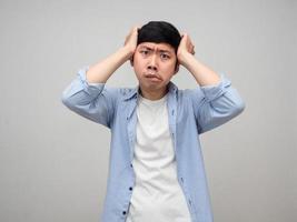 Asian man hold his head feels confused and headache isolated photo