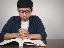 Man wear glasses joy hands wish to pass testing at table photo