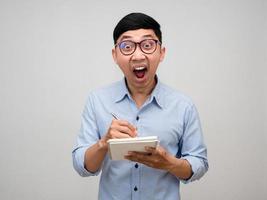 Asian businessman holding diary feels shocked isolated photo