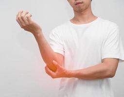 Male employee elbow pain from hard working office syndrome photo