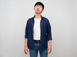 Asian man standing feels tried about hard working isolated photo