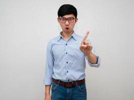 Asian businessman wear glasses show swing finger with disagree say no isolated photo