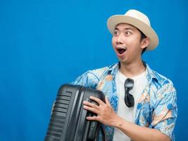 Traveler man hold luggage feels excited looking at copy space photo
