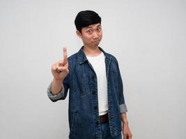 Positive asian man jeans shirt gesture show one finger up isolated photo