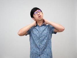 Male employee wear glasses feels pain his neck from hard working isolated photo