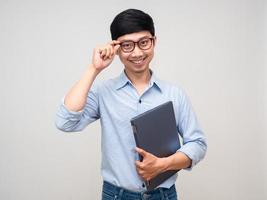 Handsome asian man hold laptop smile and posing smart isolated photo