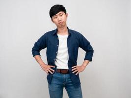 Thai man standing hands at waist feels bored and tried isolated photo