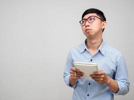 Asian businessman blue shirt feels bored about his working gesture tried isolated photo