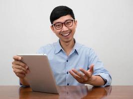 Positive businessman wear glasses holding tablet smile looking at you photo